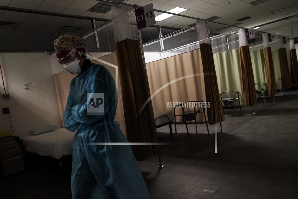 David Goldman FILE - In this Wednesday, Feb. 10, 2021 file photo, traveling registered nurse Patricia Carrete, of El Paso, Texas, walks down the hallways during a night shift at a field hospital set up to handle a surge of COVID-19 patients in Cranston, R.I. (AP Photo/David Goldman, File)