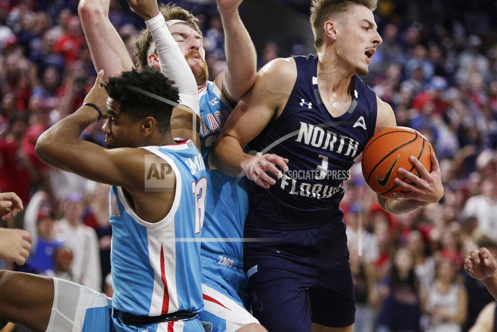 Young Kwak North Florida forward Carter Hendricksen, right, secures a rebound next to Gonzaga guard Malachi Smith, left, and Drew Timme during the first half of an NCAA college basketball game, Monday, Nov. 7, 2022, in Spokane, Wash. (AP Photo/Young Kwak)