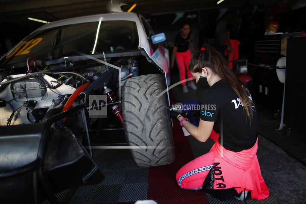 Natacha Pisarenko Vitarti Girl’s Team mechanic Paula Salazar works on driver Karina Dobal's car at pits at the Oscar y Juan Galvez track in Buenos Aires, Argentina, Friday, April 2, 2021. While many auto racing competitions are open to both male and female drivers, it's rare to see women making up the entire crew checking engines, putting on tires and analyzing race times, like the all-female Vitarti Girl’s Team. (AP Photo/Natacha Pisarenko)