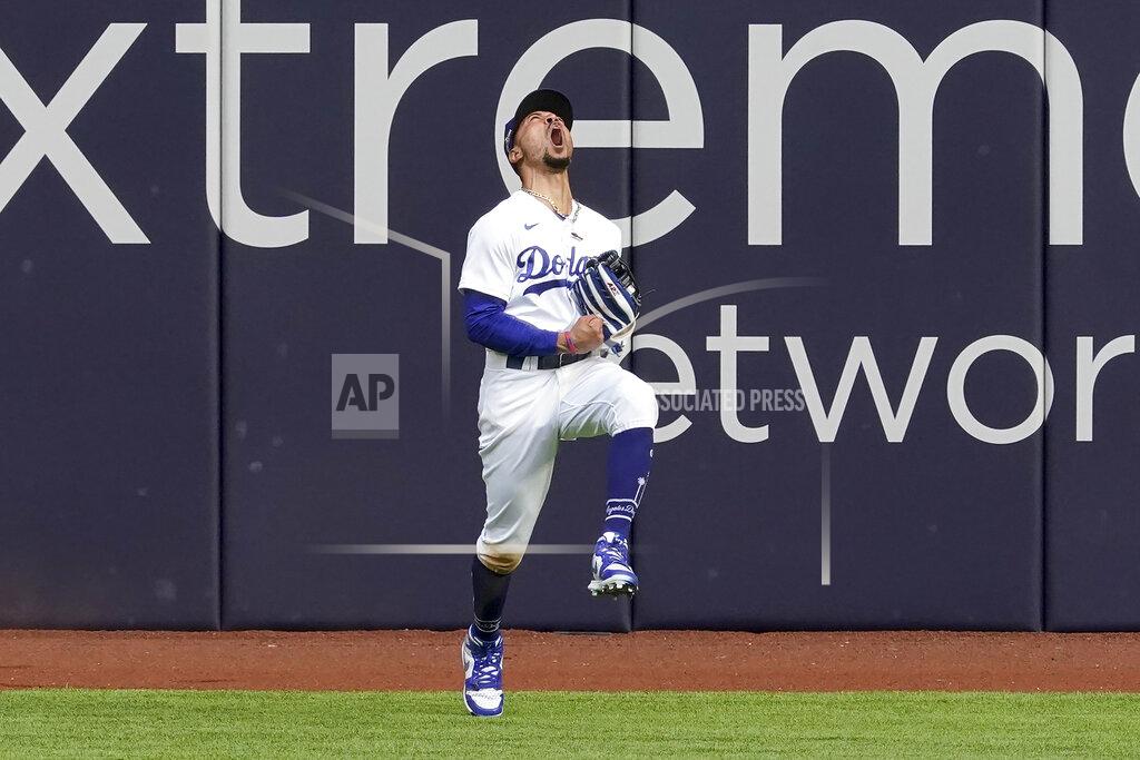 Tony Gutierrez Los Angeles Dodgers right fielder Mookie Betts celebrates after robbing Atlanta Braves' Marcell Ozuna of a home during the fifth inning in Game 6 of a baseball National League Championship Series Saturday, Oct. 17, 2020, in Arlington, Texas. (AP Photo/Tony Gutierrez)