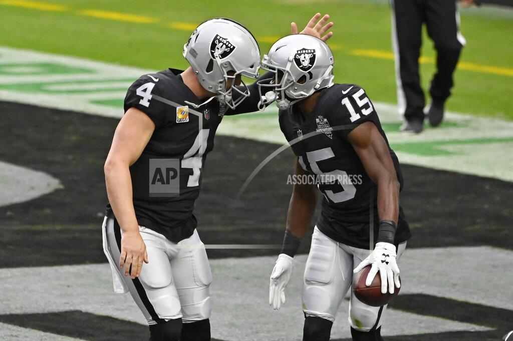 David Becker Las Vegas Raiders quarterback Derek Carr (4) celebrates after wide receiver Nelson Agholor (15) scored a touchdown against the Tampa Bay Buccaneers during the first half of an NFL football game, Sunday, Oct. 25, 2020, in Las Vegas. (AP Photo/David Becker)