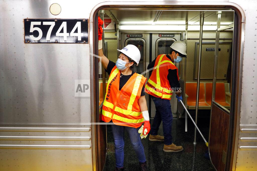 John Minchillo FILE - In this July 2, 2020, file photo, contractors clean subway cars at the 96th Street station to control the spread of COVID-19, in New York. New York's Metropolitan Transportation Authority has approved a budget, Wednesday, Dec. 16, 2020, that doesn't include threatened service cuts and fare hikes, though officials say those options remain a possibility. (AP Photo/John Minchillo, File)