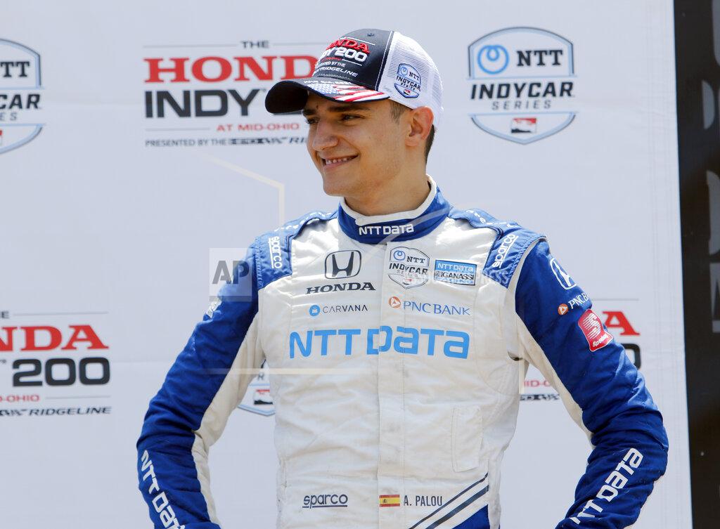 Tom E. Puskar FILE - Alex Palou smiles in victory lane after placing third in an IndyCar race at Mid-Ohio Sports Car Course in Lexington, Ohio, in this Sunday, July 4, 2021, file photo. When a pair of poor finishes cost Palou the IndyCar points lead, the second-year driver found teammate Jimmie Johnson for a pair of pep talks. Johnson may be an IndyCar rookie on the track, but the intangibles he brings to Chip Ganassi Racing as a seven-time NASCAR champion are invaluable. (AP Photo/Tom E. Puskar, File)