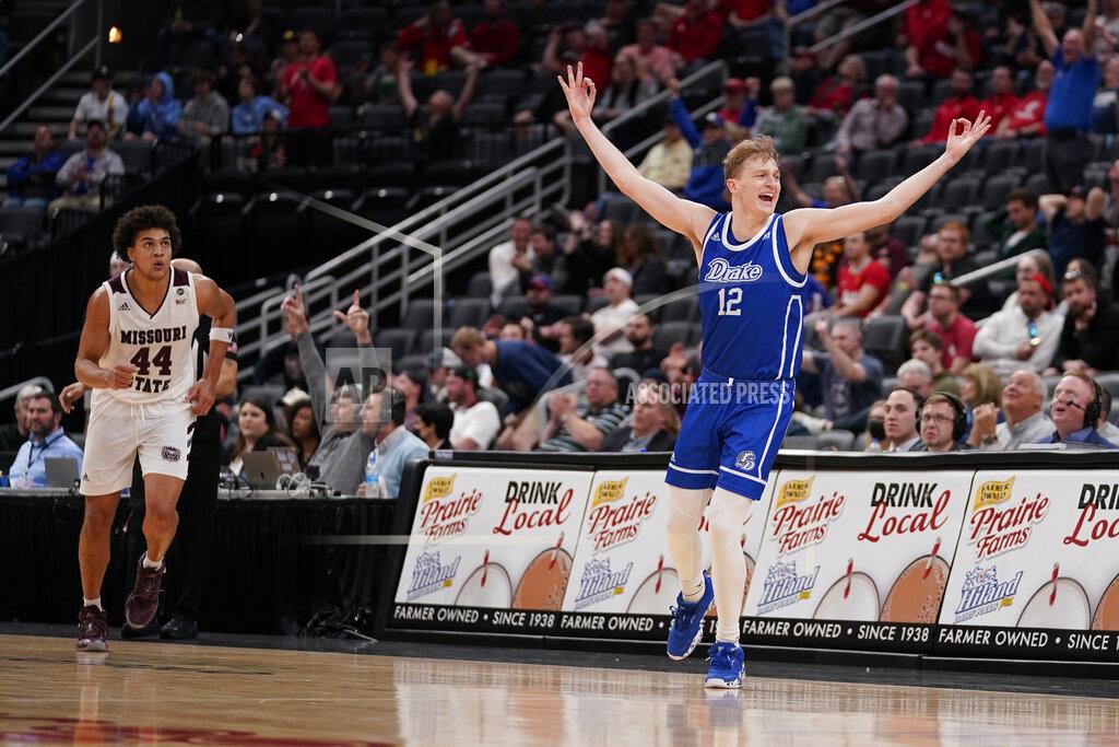 Jeff Roberson Drake's Tucker Devries (12) celebrates after making a 3-point basket as Missouri State's Gaige Prim (44) watches during overtime of an NCAA college basketball game in the semifinal round of the Missouri Valley Conference tournament Saturday, March 5, 2022, in St. Louis. Drake won 79-78. (AP Photo/Jeff Roberson)