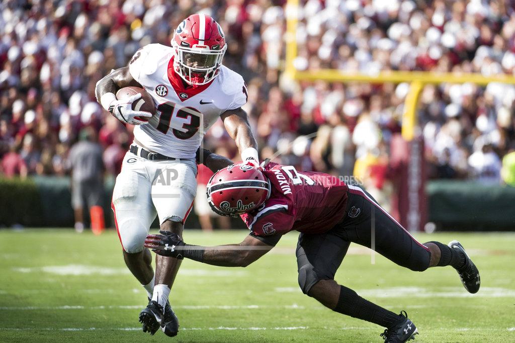 Sean Rayford Georgia running back Elijah Holyfield (13) runs with the ball against South Carolina defensive back Keisean Nixon (9) during the first half of an NCAA college football game Saturday, Sept. 8, 2018, in Columbia, S.C. (AP Photo/Sean Rayford)
