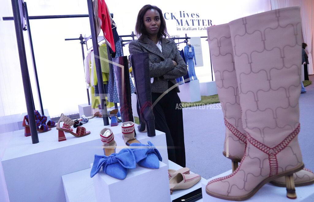 Antonio Calanni Fashion designer Judith Borsetto, founder of label Judith Saint Jermain, poses in front of her creations, part of the Black Lives Matter Spring Summer 2022 collective fashion event, unveiled during the Milan Fashion Week, in Milan, Italy, Tuesday, Sept. 21, 2021. (AP Photo/Antonio Calanni)