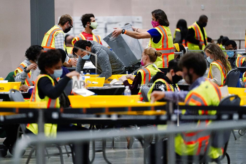 Matt Slocum FILE - In this Nov. 3, 2020, file photo, Philadelphia election workers process mail-in and absentee ballots for the general election, at the Pennsylvania Convention Center, in Philadelphia. Democrats plan to move quickly on one of the first bills of the new Congress, which would set federal election standards. The For the People Act would require states to offer early voting, same-day registration and the option of absentee voting for all registered voters. (AP Photo/Matt Slocum, File)