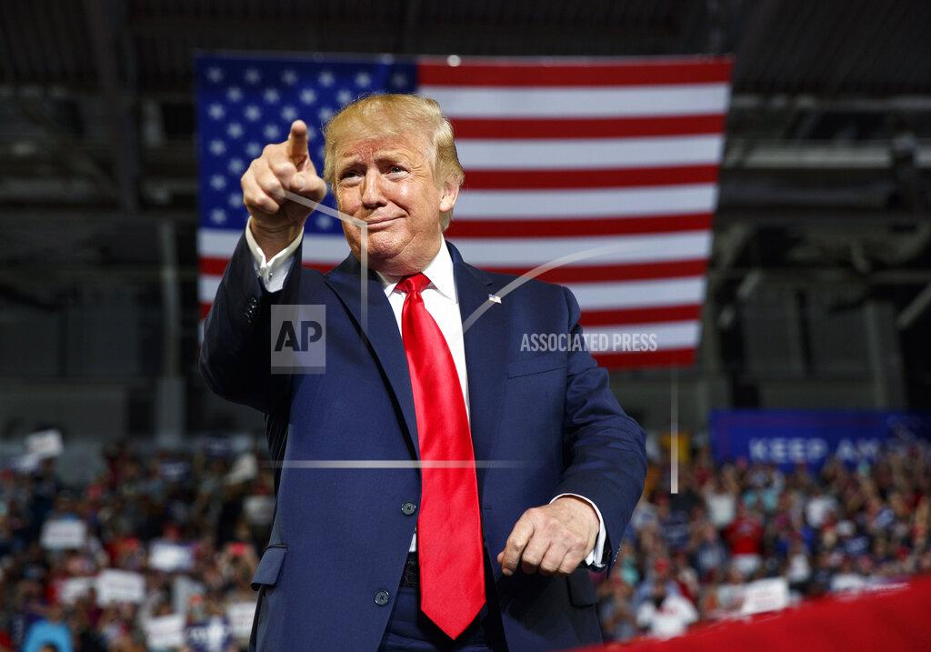 FILE - In this Wednesday, July 17, 2019 file photo, President Donald Trump gestures to the crowd as he arrives to speak at a campaign rally at Williams Arena in Greenville, N.C. Donald Trump’s first impeachment trial centered on a phone call that Americans never heard with the leader of a country far away, Ukraine. His second was far different. It centered on the rage, violence and anguish of one day in Washington itself. Together the two impeachment trials Trump faced illustrated his ability to escape consequences for actions that even many Republicans denounced. (AP Photo/Carolyn Kaster, File)