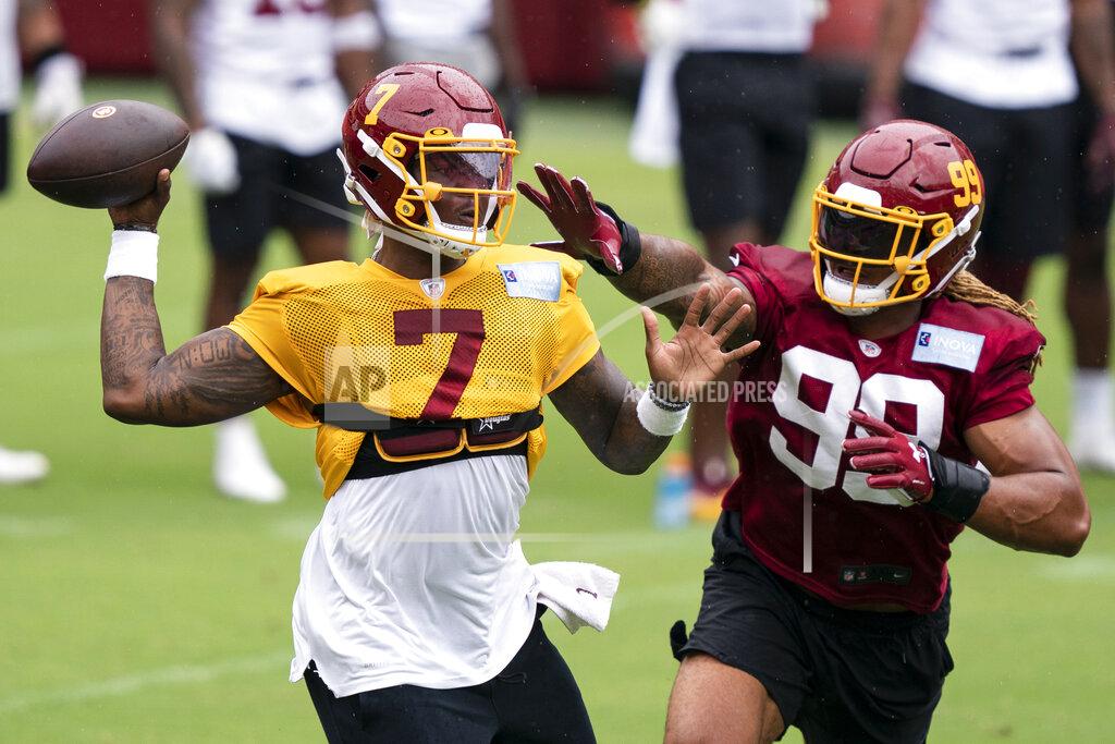 Alex Brandon Washington quarterback Dwayne Haskins Jr. (7) passes under pressure from defensive end Chase Young (99) during an NFL football practice at FedEx Field, Monday, Aug. 31, 2020, in Washington. (AP Photo/Alex Brandon)