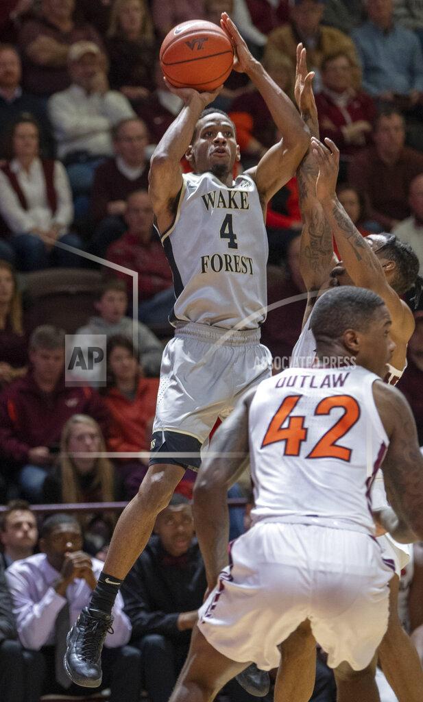 Don Petersen Wake Forest guard Torry Johnson (4) shoots over Virginia Tech guard Ty Outlaw (42) during the first half of an NCAA college basketball game Saturday, Jan. 19, 2019, in Blacksburg, Va. (AP Photo/Don Petersen)