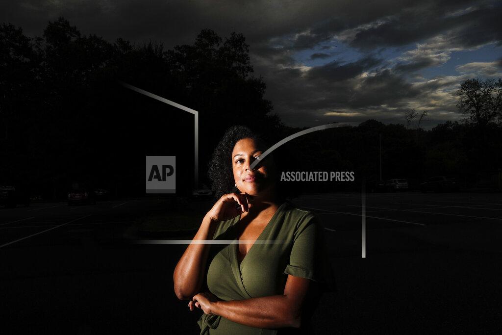 Brynn Anderson FILE - In this Friday, July 24, 2020 file photo, Charisse Davis poses for a portrait in Marietta, Ga. Davis, who serves on the school board in suburban Cobb County, was part of a wave of Black women elected to public office in recent years. Women like her led the charge that ushered Joe Biden to an unlikely victory in Georgia. “We won, but it doesn’t really feel like we did,” she said. (AP Photo/Brynn Anderson)