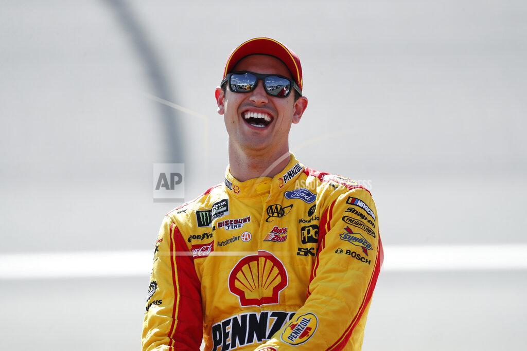 Paul Sancya Joey Logano laughs during qualifications for a NASCAR Cup Series auto race at Michigan International Speedway in Brooklyn, Mich., Friday, Aug. 9, 2019. (AP Photo/Paul Sancya)