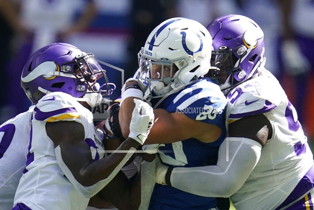 Michael Conroy CORRECTS PLAYER TO VIKINGS' HOLTON HILL INSTEAD OF HARRISON SMITH - Indianapolis Colts' Jonathan Taylor (28) is tackled by Minnesota Vikings' Holton Hill (24) and Jaleel Johnson (94) during the second half of an NFL football game, Sunday, Sept. 20, 2020, in Indianapolis. (AP Photo/Michael Conroy)