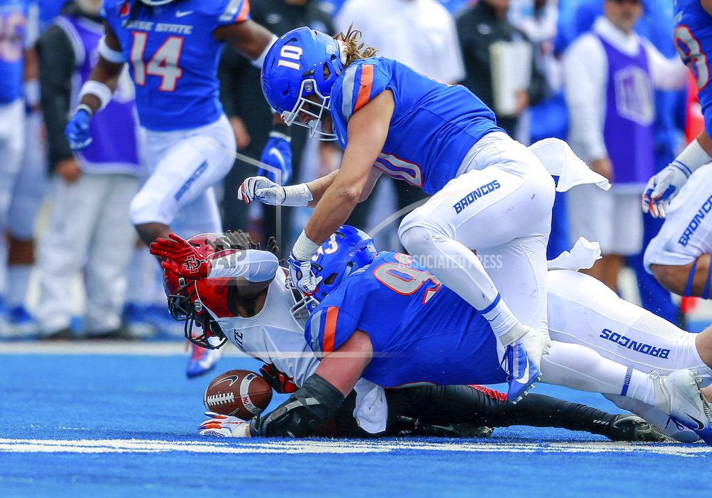 Steve Conner Boise State defensive tackle Chase Hatada (93) knocks the ball loose from San Diego State wide receiver BJ Busbee, left, in the first half of an NCAA college football game, Saturday, Oct. 6, 2018, in Boise, Idaho. Boise State recovered the fumble. (AP Photo/Steve Conner)