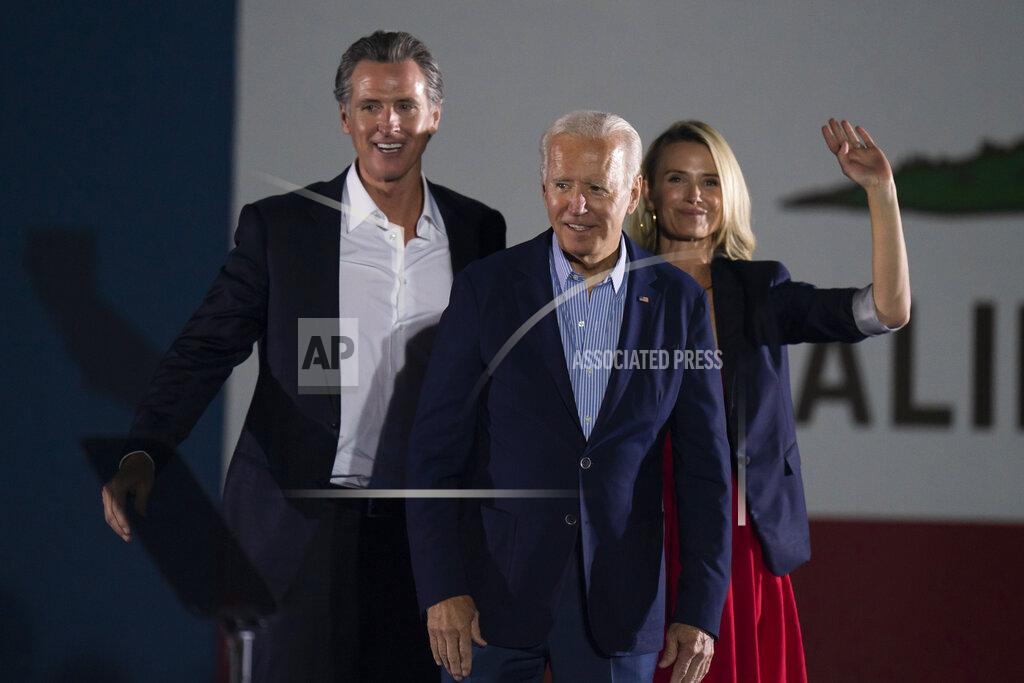 Jae C. Hong FILE — In this Sept. 13, 2021, file photo President Joe Biden, center, smiles to the crowd as he is flanked by California Gov. Gavin Newsom and Jennifer Siebel Newsom at a rally ahead of the California gubernatorial recall election in Long Beach, Calif. In the recall election, Newsom won big in coastal urban areas such as Los Angeles County, while the pro-recall side performed better in California's Central Valley and northern areas. (AP Photo/Jae C. Hong, File)