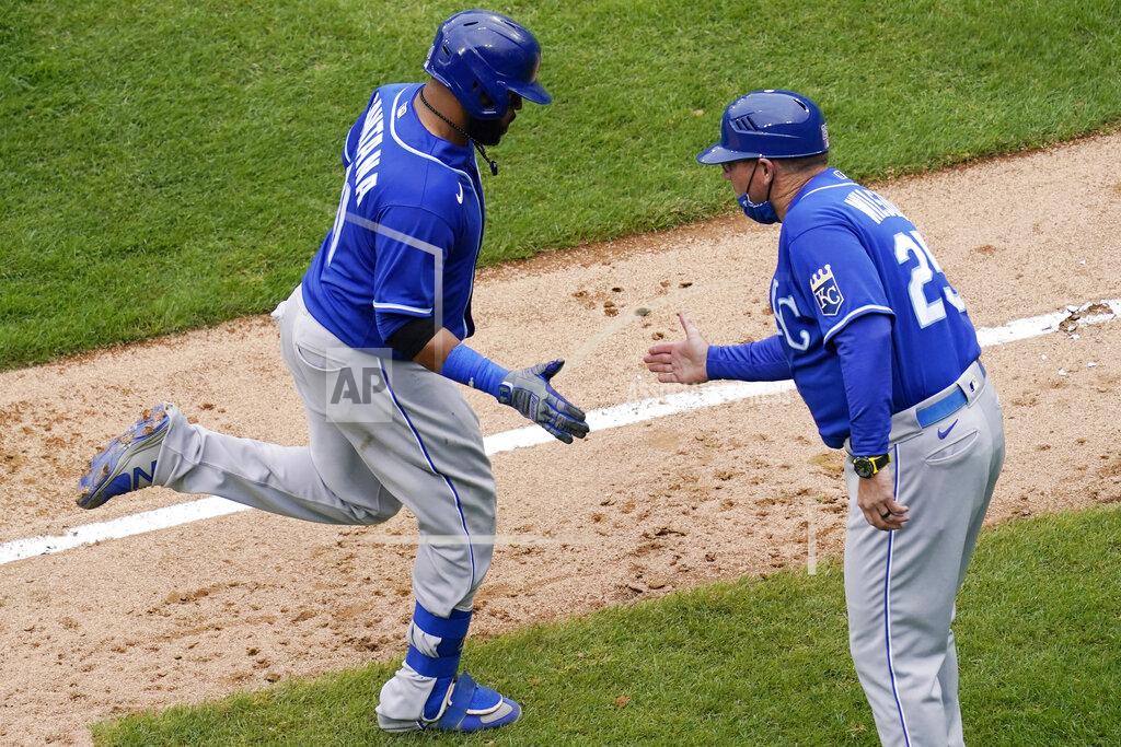 Nam Y. Huh Kansas City Royals' Carlos Santana, left, rounds the bases as he celebrates with third base coach Vance Wilson after hitting a solo home run during the ninth inning of a baseball game against the Chicago White Sox in Chicago, Sunday, April 11, 2021. (AP Photo/Nam Y. Huh)