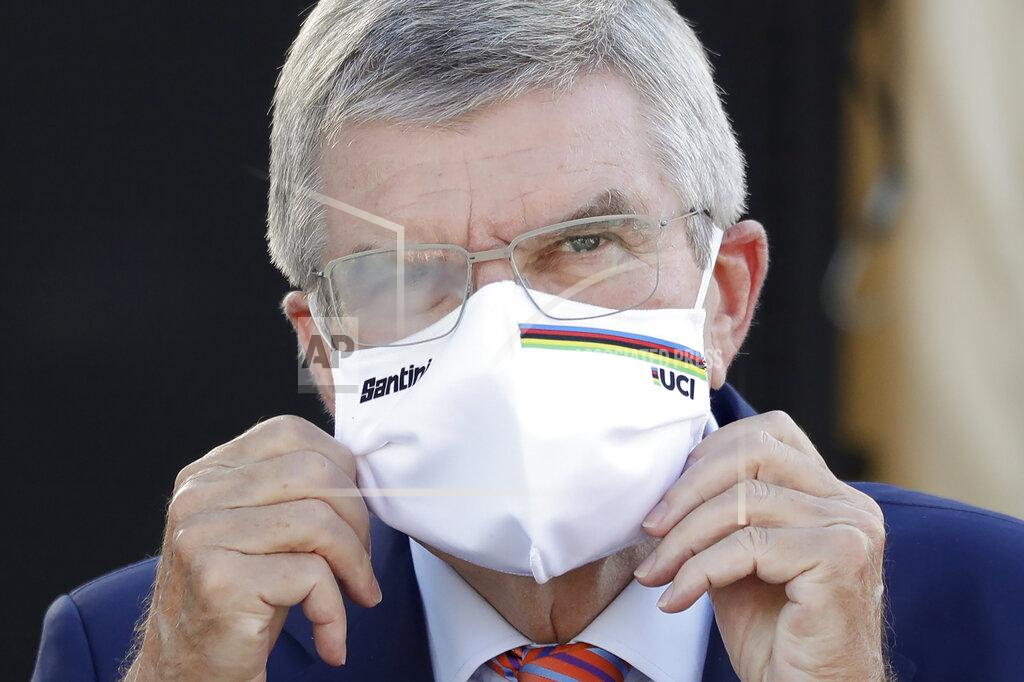 IOC President Thomas Bach waits for the podium ceremony for the women's elite event at the road cycling World Championships in Imola, Italy on Sept. 26, 2020. Organizers of a South Korean award say International Olympic Committee President Thomas Bach has decided not to visit in person this week and accept the prize because of concerns about the coronavirus pandemic. Bach was named winner of the Seoul Peace Prize last month and was to receive the award on Monday, Oct. 26, 2020. (AP Photo/Andrew Medichini)