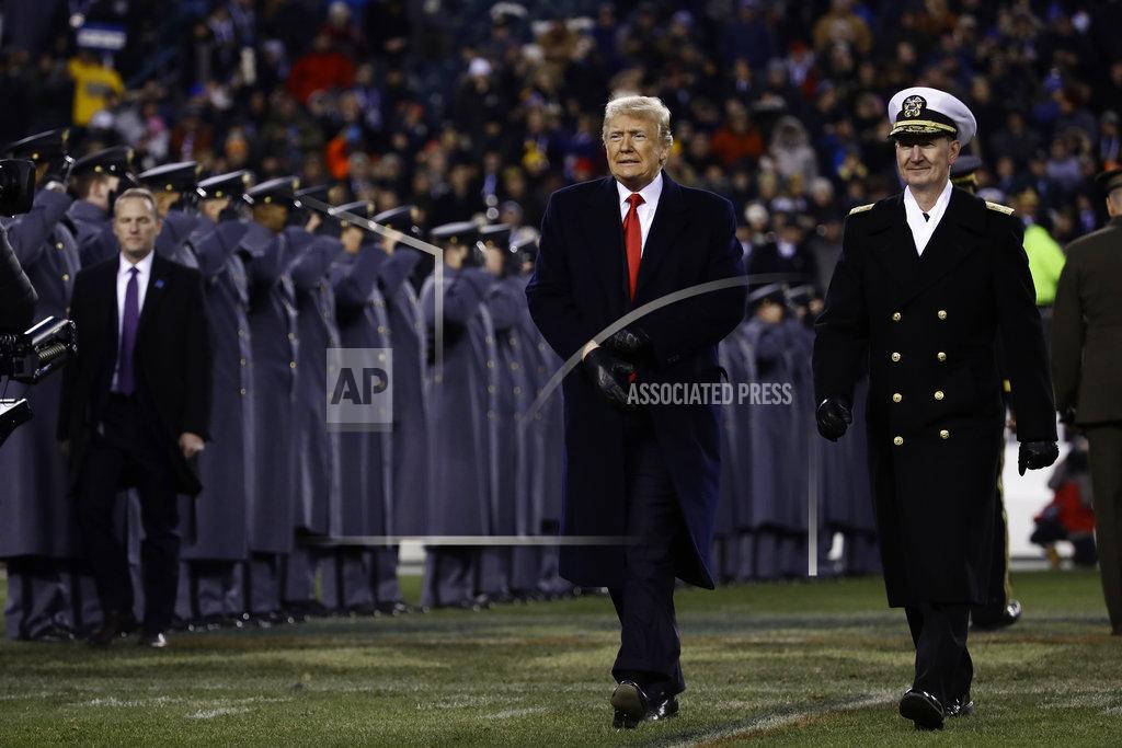 Matt Rourke President Donald Trump, left, walks with Naval Academy Superintendent Vice Adm. Ted Carter, right, across the field after the first half of an NCAA college football game between the Army and the Navy, Saturday, Dec. 8, 2018, in Philadelphia. (AP Photo/Matt Rourke)