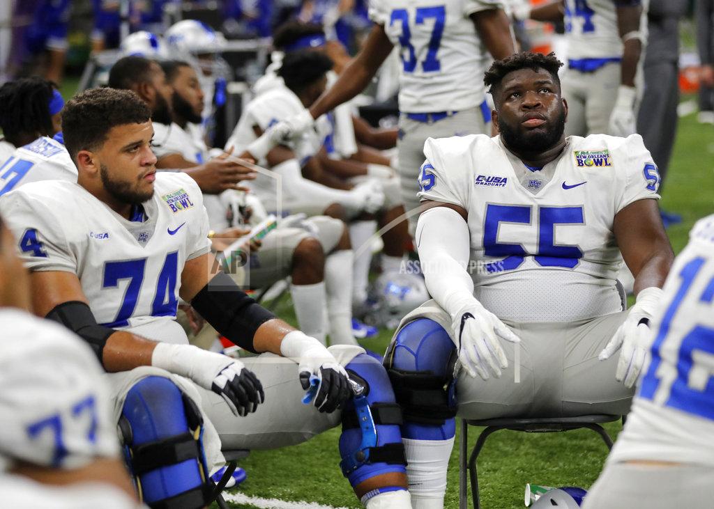 Gerald Herbert Middle Tennessee offensive linemen Robert Behanan (74) and Carlos Johnson (55) react on the bench in the second half of the New Orleans Bowl NCAA college football game against Appalachian State in New Orleans, Saturday, Dec. 15, 2018. Appalachian State won 45-13. (AP Photo/Gerald Herbert)