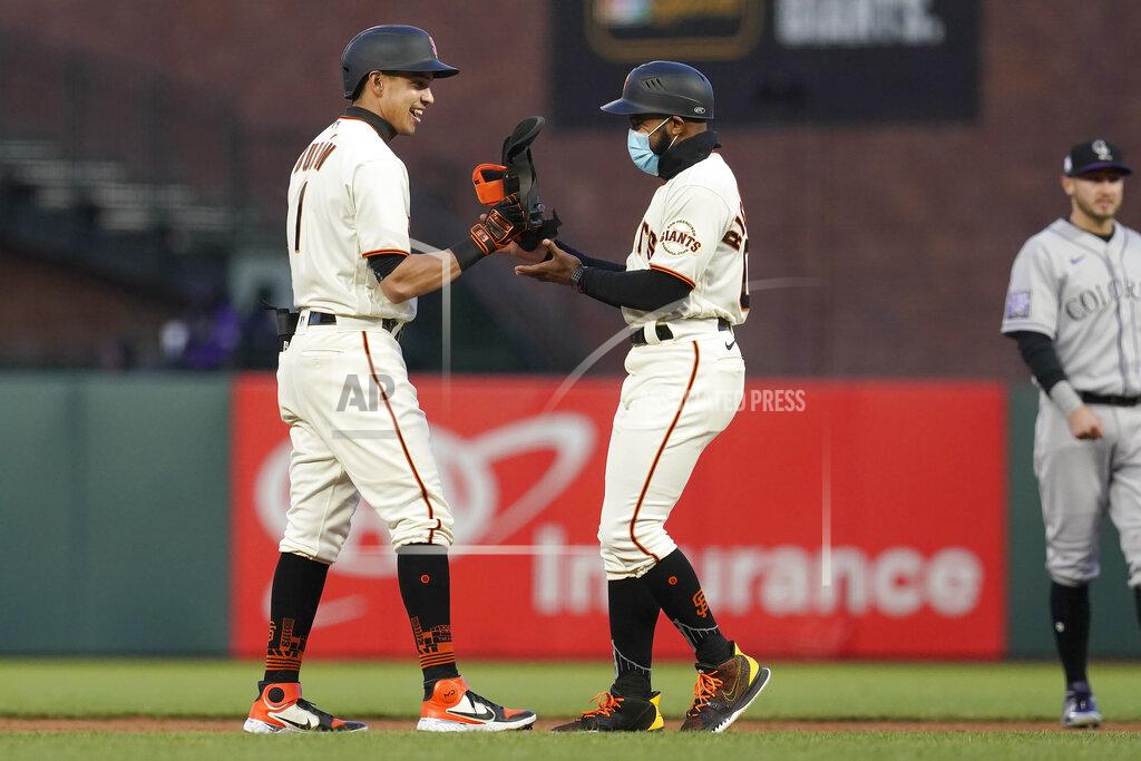 Jeff Chiu San Francisco Giants' Mauricio Dubon, left, is congratulated by first base coach Antoan Richardson after hitting a three-run double against the Colorado Rockies during the second inning of a baseball game in San Francisco, Monday, April 26, 2021. (AP Photo/Jeff Chiu)