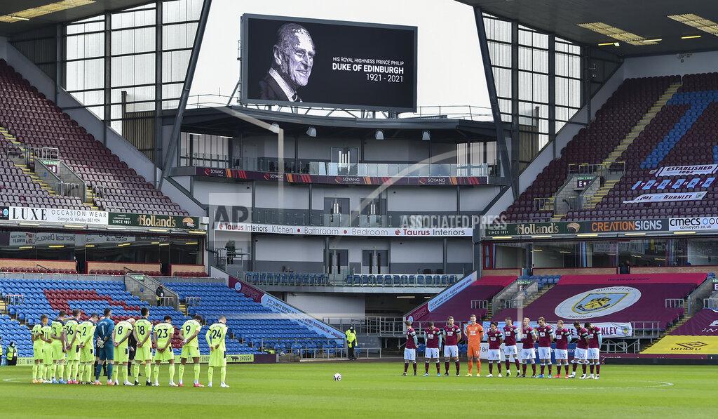 Peter Powell Players and match officials stand for two minutes silence prior to kick off to mark the passing of Prince Philip at the age of 99 at the English Premier League soccer match between Burnley and Newcastle United at Turf Moor in Burnley, England, Sunday April 11, 2021. (AP Photo/Peter Powell/Pool)