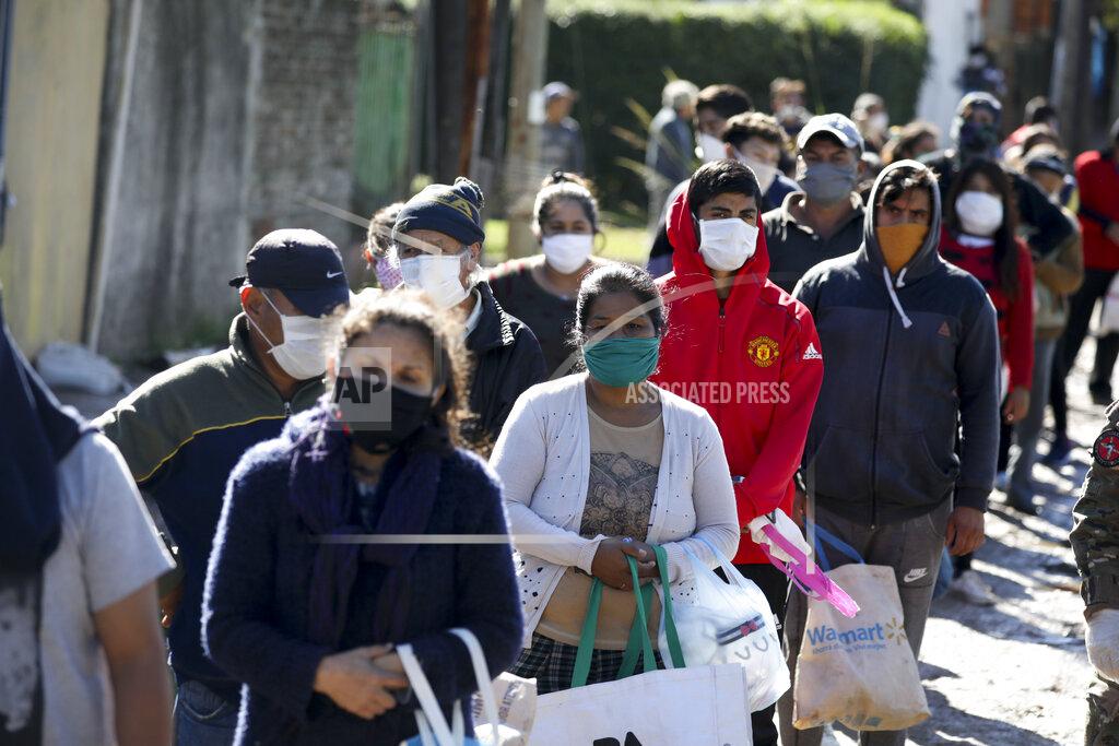 Natacha Pisarenko People line up to receive food handouts from soldiers during a government-ordered lockdown to curb the spread of the new coronavirus in Buenos Aires, Argentina, Wednesday, April 29, 2020. (AP Photo/Natacha Pisarenko)