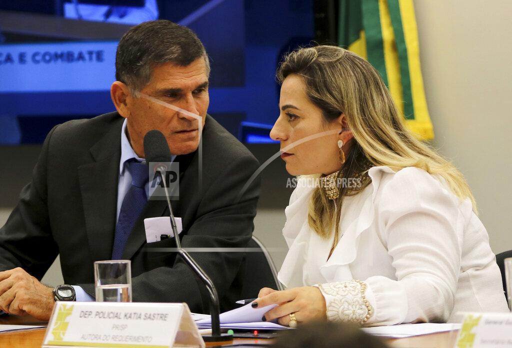 Wilson Dias FILE - In this April 24, 2019 handout photo, Congresswoman Katia Sastre, an ally of President Jair Bolsonaro, talks with then Secretary of Government Minister Alberto dos Santos Cruz, at Congress in Brasilia, Brazil. Sastre is backing President Jair Bolsonaro’s push to deliver a gun to every Brazilian who wants one, and dismisses public security experts’ concerns about the president’s four recently issued gun decrees. (Wilson Dias/Agencia Brasil via AP File)