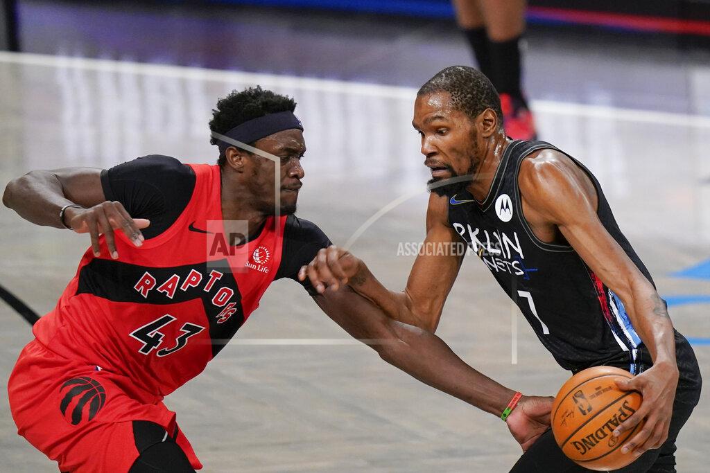 Toronto Raptors' Pascal Siakam (43) defends against Brooklyn Nets' Kevin Durant (7) during the first half of an NBA basketball game Friday, Feb. 5, 2021, in New York. (AP Photo/Frank Franklin II)