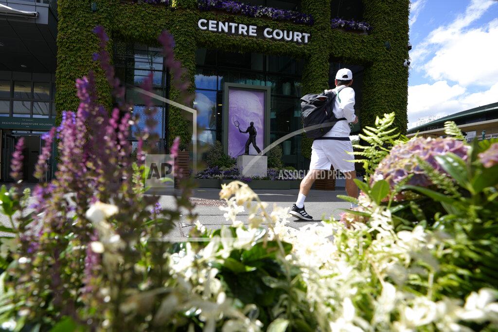 Kirsty Wigglesworth A man walks past the statue to former Wimbledon champion Fred Perry ahead of the Wimbledon tennis championships in London, Sunday, June 26, 2022. (AP Photo/Kirsty Wigglesworth)