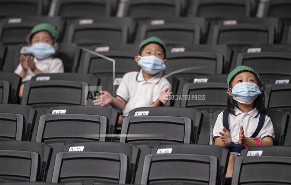 Bob Martin Local schoolchildren applaud and are the only spectators allowed into the venue as they sit socially distanced and watch the United States and Germany play in a preliminary round Group B wheelchair basketball match at the Tokyo 2020 Paralympic Games on Thursday, Aug. 26, 2021, in Tokyo. (Bob Martin for OIS via AP)