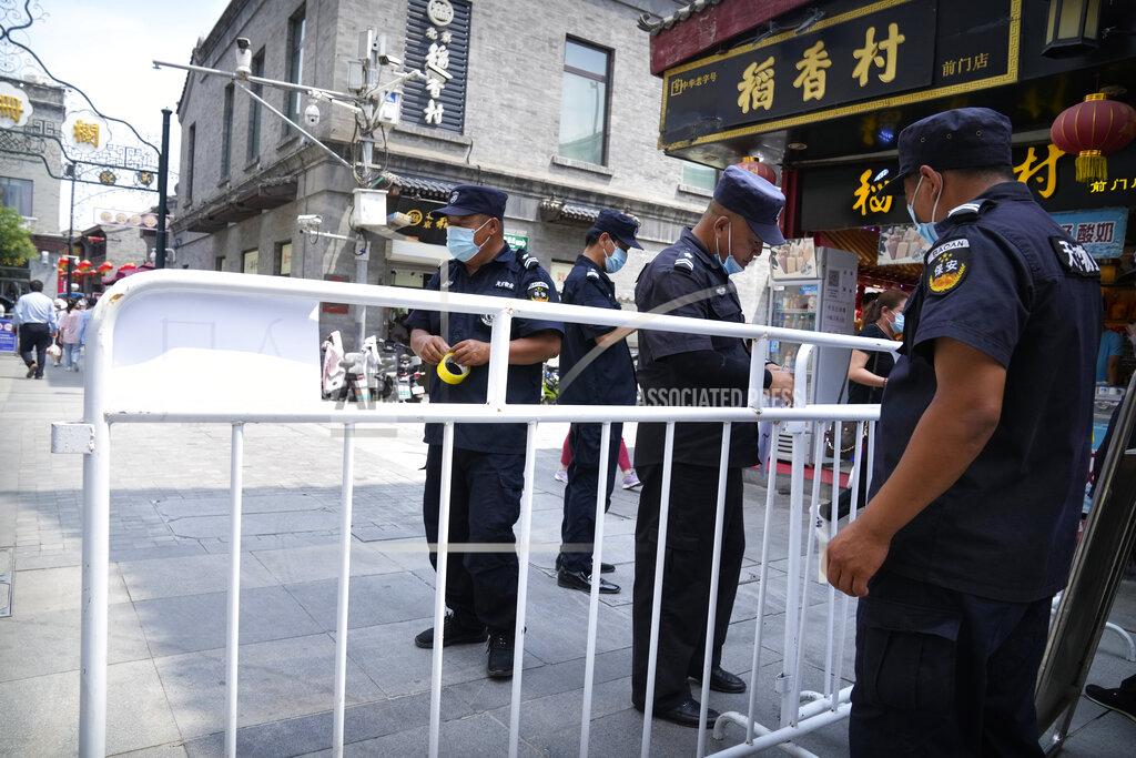 Mark Schiefelbein Security guards put up barriers for access control at a tourist shopping street in Beijing, Tuesday, Aug. 3, 2021. Chinese authorities announced Tuesday mass coronavirus testing in Wuhan as an unusually wide series of COVID-19 outbreaks reached the city where the disease was first detected in late 2019. The current outbreaks, while still in the hundreds of cases in total, have spread much more widely than previous ones, reaching multiple provinces and cities including the capital, Beijing. (AP Photo/Mark Schiefelbein)