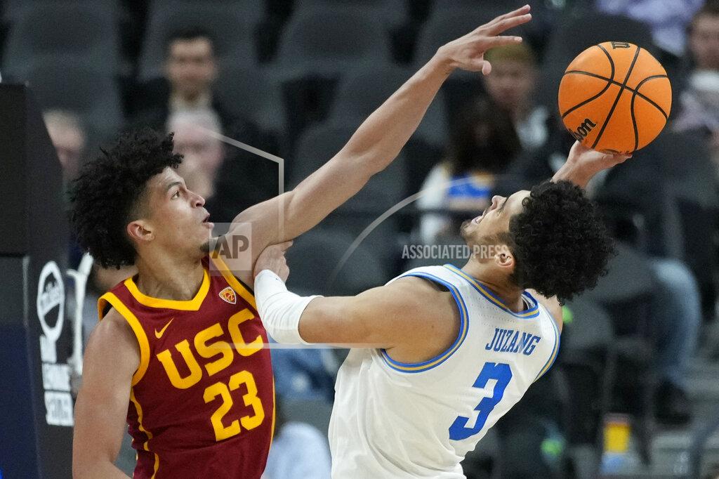 John Locher Southern California's Max Agbonkpolo (23) guards UCLA's Johnny Juzang (3) during the second half of an NCAA college basketball game in the semifinal round of the Pac-12 tournament Friday, March 11, 2022, in Las Vegas. (AP Photo/John Locher)