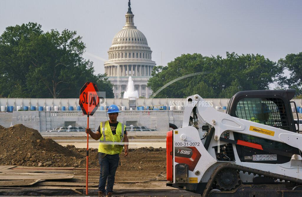 J. Scott Applewhite Workers repair a park near the Capitol in Washington, Wednesday, July 21, 2021, as senators struggle to reach a compromise over how to pay for nearly $1 trillion in public works spending, a key part of President Joe Biden's agenda. (AP Photo/J. Scott Applewhite)