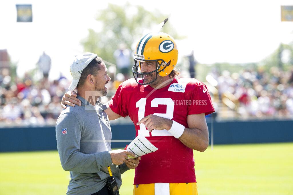 Samantha Madar Green Bay Packers quarterback Aaron Rodgers (12) flips head coach Matt LaFleur's hat backwards during NFL football training camp on Thursday, Aug. 4, 2022, at Ray Nitschke Field in Ashwaubenon, Wis. (Samantha Madar/The Post-Crescent via AP)