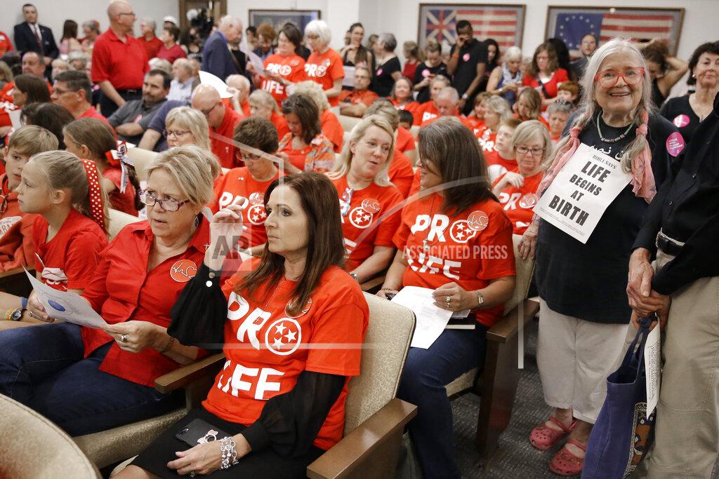 Mark Humphrey FILE - In this Aug. 12, 2019, file photo, people wait for a Senate hearing to begin to discuss a fetal heartbeat abortion ban, or possibly something more restrictive in Nashville, Tenn. The assertion by proponents that abortion as early as six weeks into pregnancy “stops a beating heart” was arguably the stroke of political genius that helped so-called “heartbeat bills” defy constitutional concerns to become law in 12 states. None has taken effect due to court challenges, the latest being argued Thursday, April 29, 2021, in Tennessee. (AP Photo/Mark Humphrey, File)