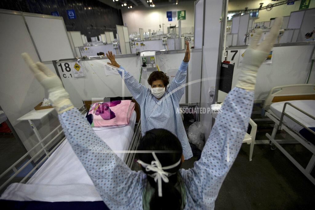 Fernando Llano FILE - In this March 11, 2021 file photo, directed by a nurse, a COVID-19 patient, back center, stretches her arms as part of a fitness program in a field hospital built inside the Citibanamex convention center in Mexico City. Mexico’s unwillingness to spend money, do more testing, change course or react to new scientific evidence contributed to the country being one of the worst hit by the coronavirus pandemic, according to a report released the third week of April, by the University of California, San Francisco. (AP Photo/Fernando Llano, File)