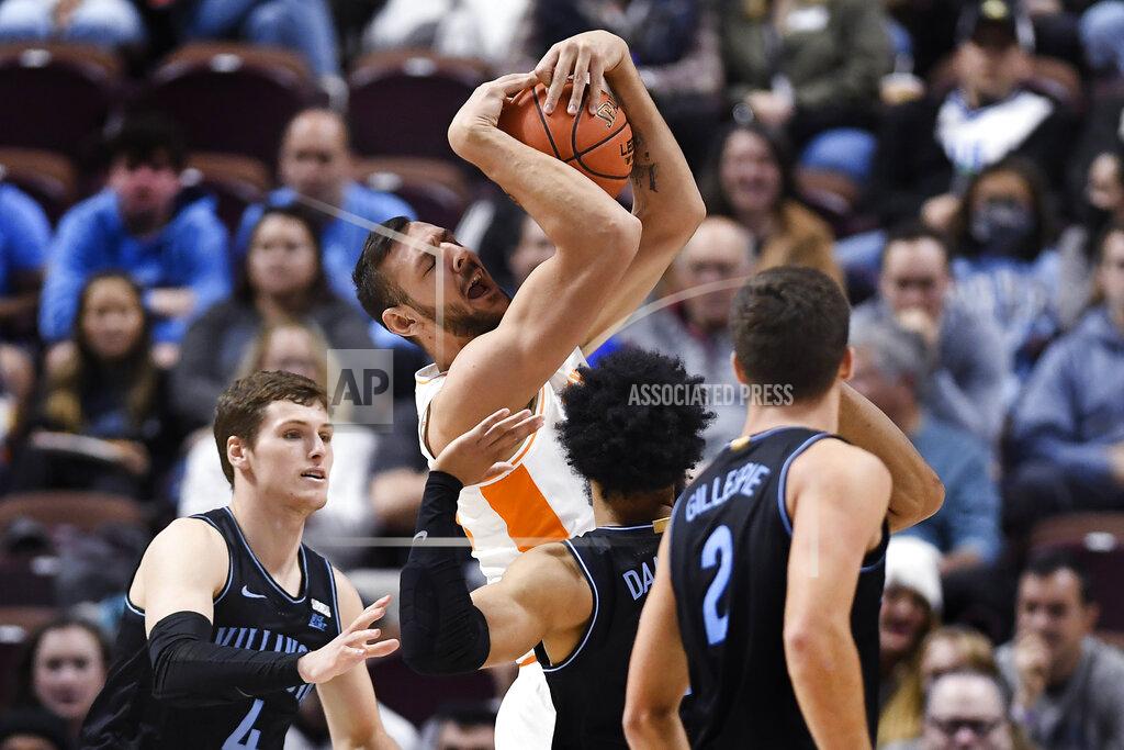 Jessica Hill Tennessee's Santiago Vescovi, center, holds onto the ball under pressure from Villanova's Chris Arcidiacono, left, and Villanova's Caleb Daniels in the second half of an NCAA college basketball game, Saturday, Nov. 20, 2021, in Uncasville, Conn. (AP Photo/Jessica Hill)