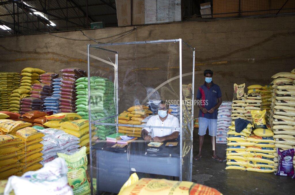 Eranga Jayawardena A Sri Lankan trader waits for customers adhering to health guidelines given by the authorities to curb the spread of coronavirus at a wholesale market in Welisara, outskirts of Colombo, Sri Lanka, Monday, May 31, 2021. (AP Photo/Eranga Jayawarden)