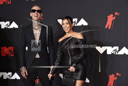 FILE - Travis Barker, left, and Kourtney Kardashian arrive at the MTV Video Music Awards at Barclays Center on Sunday, Sept. 12, 2021, in New York. A representative for the reality star and businesswoman confirmed Sunday, Oct. 17 that the couple are engaged. (Photo by Evan Agostini/Invision/AP, File)