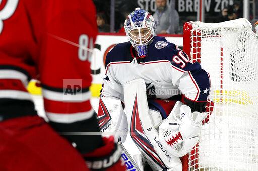Columbus Blue Jackets goaltender Elvis Merzlikins (90) watches the puck controlled by Carolina Hurricanes' Martin Necas (88) during the second period of an NHL hockey game in Raleigh, N.C., Thursday, Jan. 13, 2022. (AP Photo/Karl B DeBlaker)