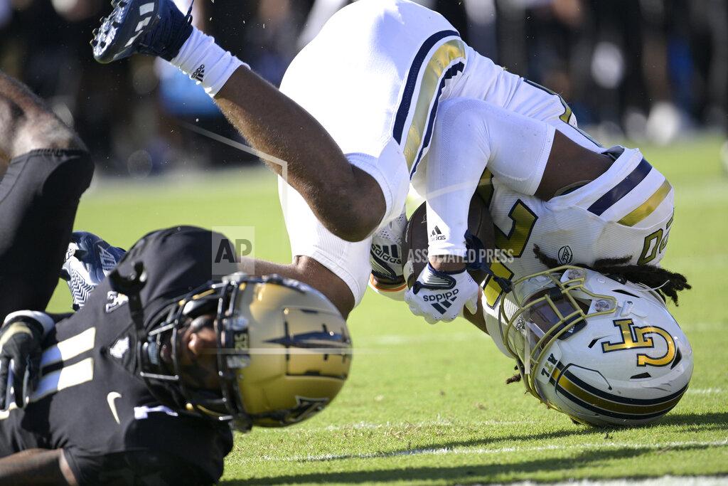 Phelan M. Ebenhack Georgia Tech defensive back LaMiles Brooks (20) comes down with an interception in the end zone on a pass intended for Central Florida wide receiver Ryan O'Keefe (4) during the first half of an NCAA college football game, Saturday, Sept. 24, 2022, in Orlando, Fla. (AP Photo/Phelan M. Ebenhack)