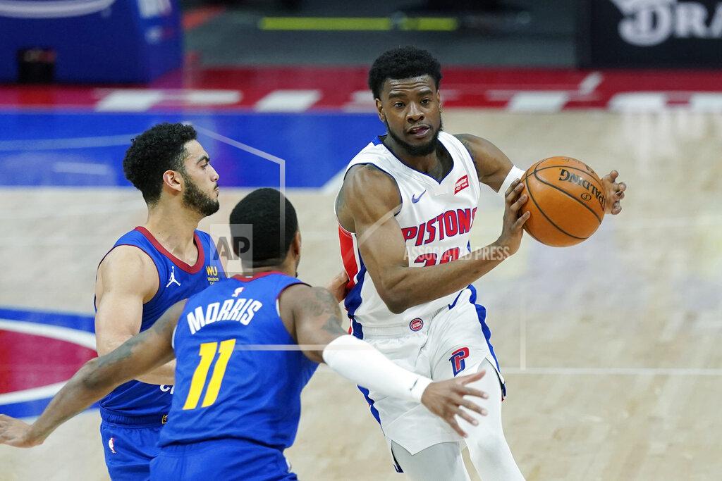 Carlos Osorio Detroit Pistons guard Josh Jackson passes as Denver Nuggets guard Monte Morris (11) and guard Markus Howard defend during the second half of an NBA basketball game, Friday, May 14, 2021, in Detroit. (AP Photo/Carlos Osorio)