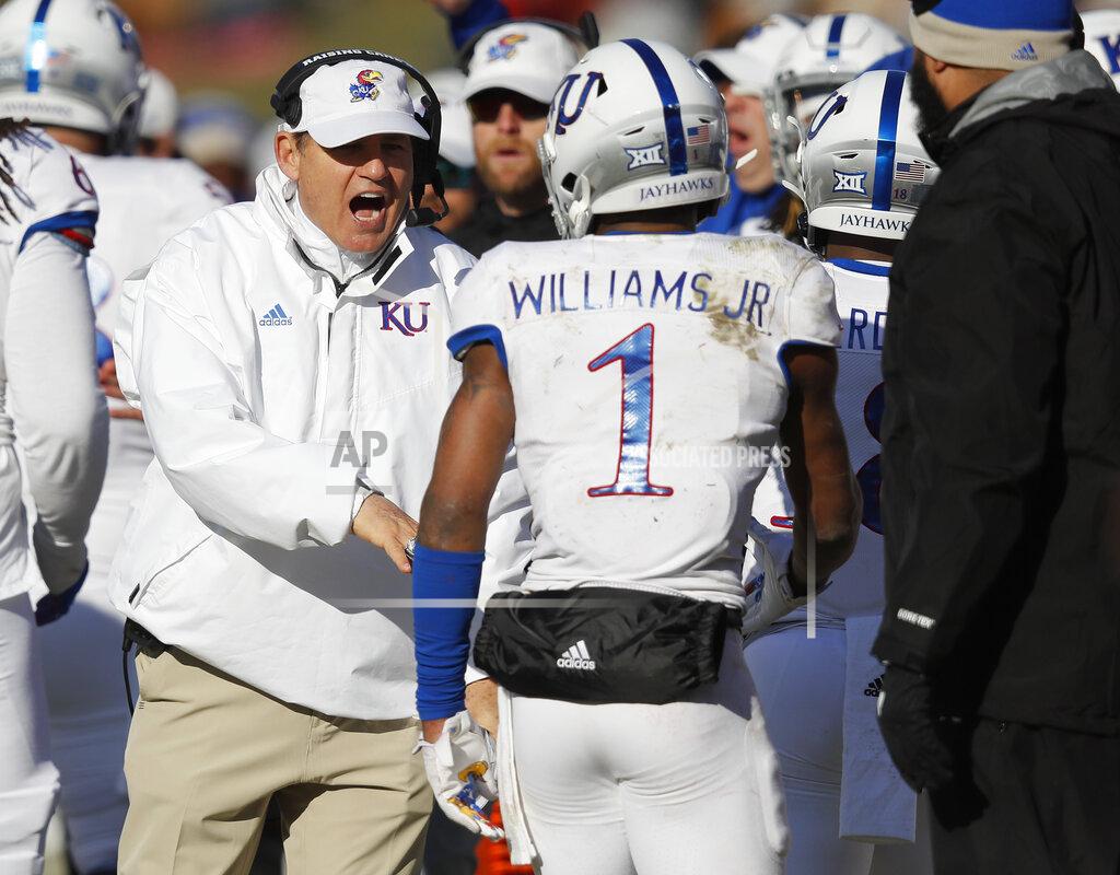 Matthew Putney Kansas head coach Les Miles, left, congratulates Kansas running back Pooka Williams, right, after a touchdown by Williams during the second half of an NCAA college football game against Iowa State, Saturday, Nov. 23, 2019, in Ames, Iowa. Iowa State won 41-31. (AP Photo/Matthew Putney)