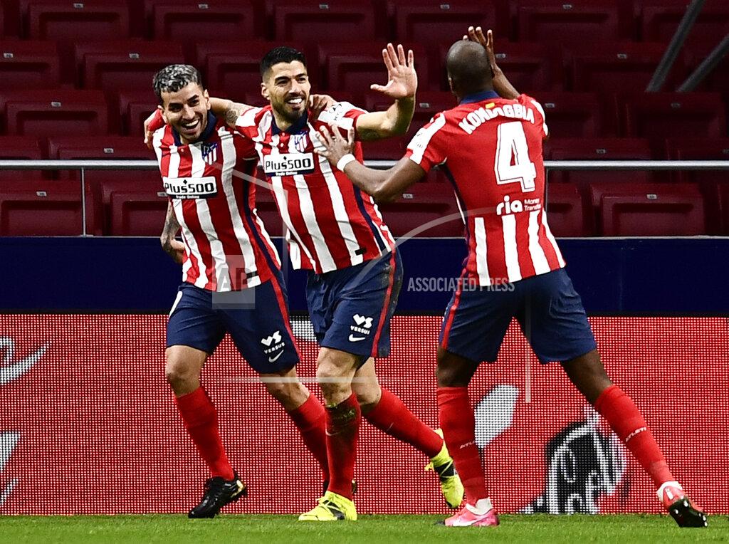 Jose Breton Atletico Madrid's Luis Suarez, center, celebrates with teammates after scoring during a La Liga soccer match between Atletico Madrid and Celta at the Wanda Metropolitano stadium in Madrid, Spain, Monday, Feb. 8, 2021. (AP Photo/Jose Breton)