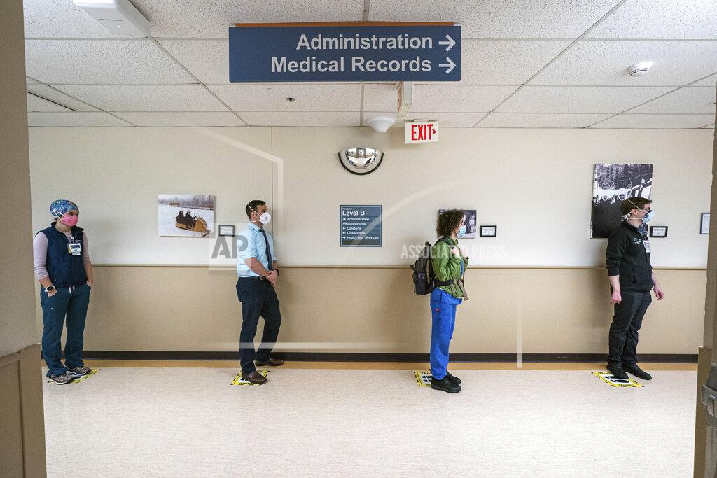 Loren Holmes FILE - In this Wednesday, Dec. 16, 2020, file photo, front-line caregivers wait in line to receive a Pfizer COVID-19 vaccine at Providence Alaska Medical Center in Anchorage, Alaska. Overwhelmed by a surge in COVID-19 patients, Providence Alaska Medical Center, Alaska’s largest hospital, on Tuesday, Sept. 14, 2021, implemented crisis standards of care, prioritizing resources and treatments to those patients who have the potential to benefit the most. (Loren Holmes/Anchorage Daily News via AP, File)