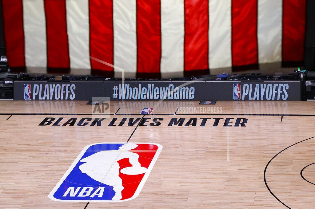 Kevin C. Cox An empty court and bench are shown following the scheduled start time of Game 5 of an NBA basketball first-round playoff series, Wednesday, Aug. 26, 2020, in Lake Buena Vista, Fla. All three NBA playoff games scheduled for Wednesday were postponed, with players around the league choosing to boycott in their strongest statement yet against racial injustice. (Kevin C. Cox/Pool Photo via AP)