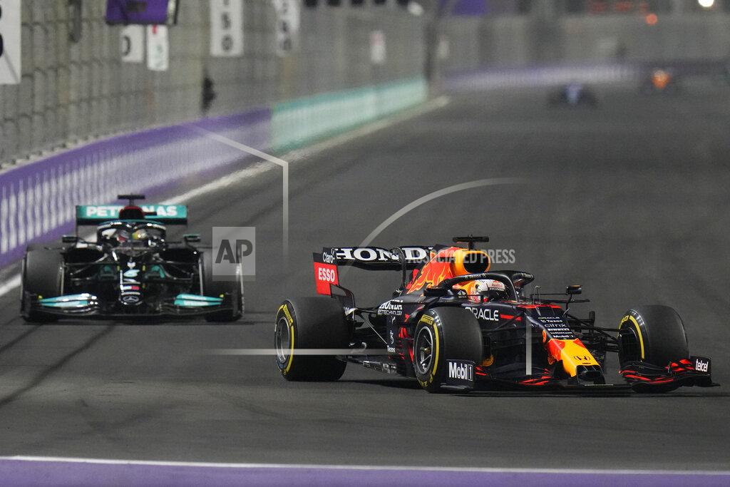 Hassan Ammar Red Bull driver Max Verstappen of the Netherlands, front, and Mercedes driver Lewis Hamilton of Britain in action t during the Formula One Saudi Arabian Grand Prix in Jiddah, Sunday, Dec. 5, 2021. (AP Photo/Hassan Ammar)