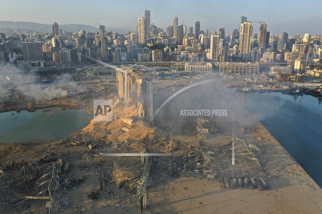 Hussein Malla FILE - In this August 5, 2020 file photo, a drone picture shows the destruction after an explosion at the seaport of Beirut, Lebanon. The mental health impact of the Beirut explosion that killed more than 200 and wounded more than 6,000 continues to lay its heavy weight on those who managed to survive the day. The blast was caused by a fire of unknown origins that ignited nearly three thousand tons of ammonium nitrates that had been left to rot in a port warehouse for years. (AP Photo/Hussein Malla, File)