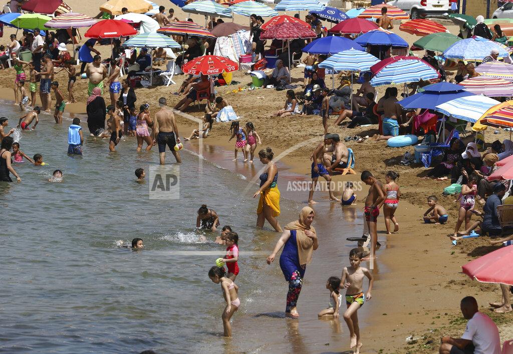 Anis Belghoul Beachgoers enjoy the el Djamila beach after its reopening in Algiers, Saturday, Aug.15, 2020. Algeria started to reopen mosques, cafes, beaches and parks Saturday after five months of virus confinement measures. Curfews are still in place in more than half of the country, which has reported more than 37,000 infections and 1,350 deaths, the third-highest virus death rate in Africa. (AP Photo/Anis Belghoul)
