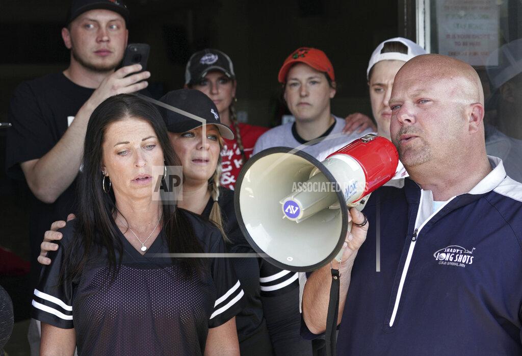 Brian Peterson Kris Schiffler, right, the owner of Shady's Hometown Tavern in Albany, Minn. tells supporters outside his business that he's not opening his bar and grill Monday, May 18, 2020, on the advice of his attorney, after getting a call from Minnesota Attorney General Keith Ellison. (Brian Peterson/Star Tribune via AP)